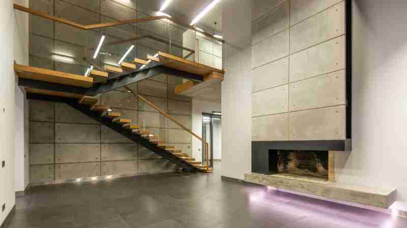 Spacious modern interior featuring a minimalist staircase and fireplace., tags: und für - pexel